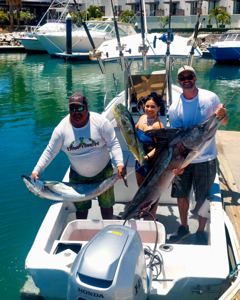 Angler holding striped marlin caught near San Luis Bank, San Jose del Cabo