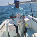 Catch and release moment with a roosterfish in the crystal-clear inshore waters of Los Cabos.