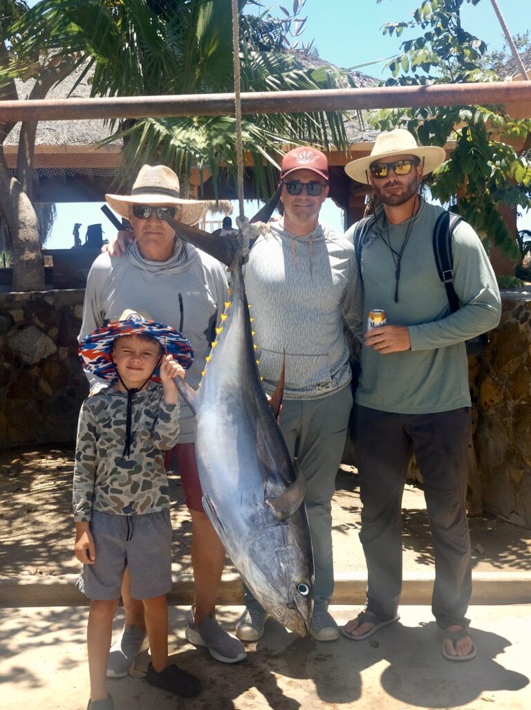 Angler holding 80-pound yellowfin tuna caught on jig near San Luis – Baja fishing action