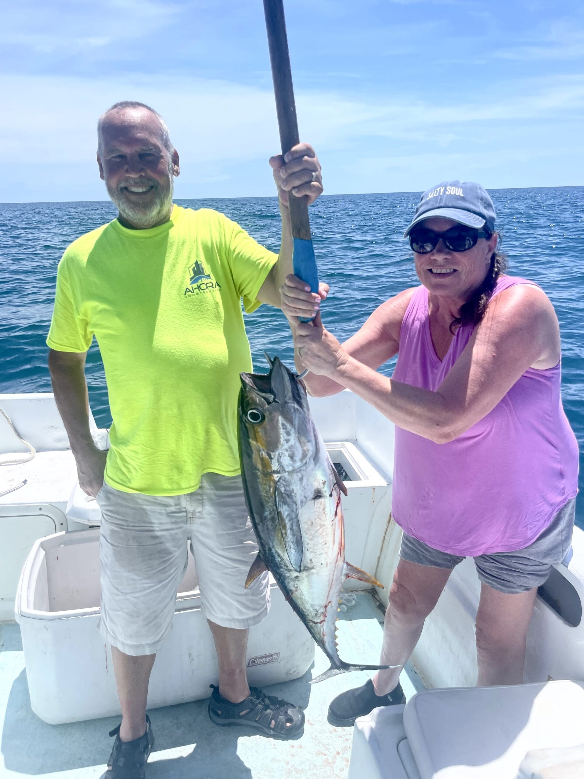 Clients holding 40lb yellowfin tuna caught in Cabo