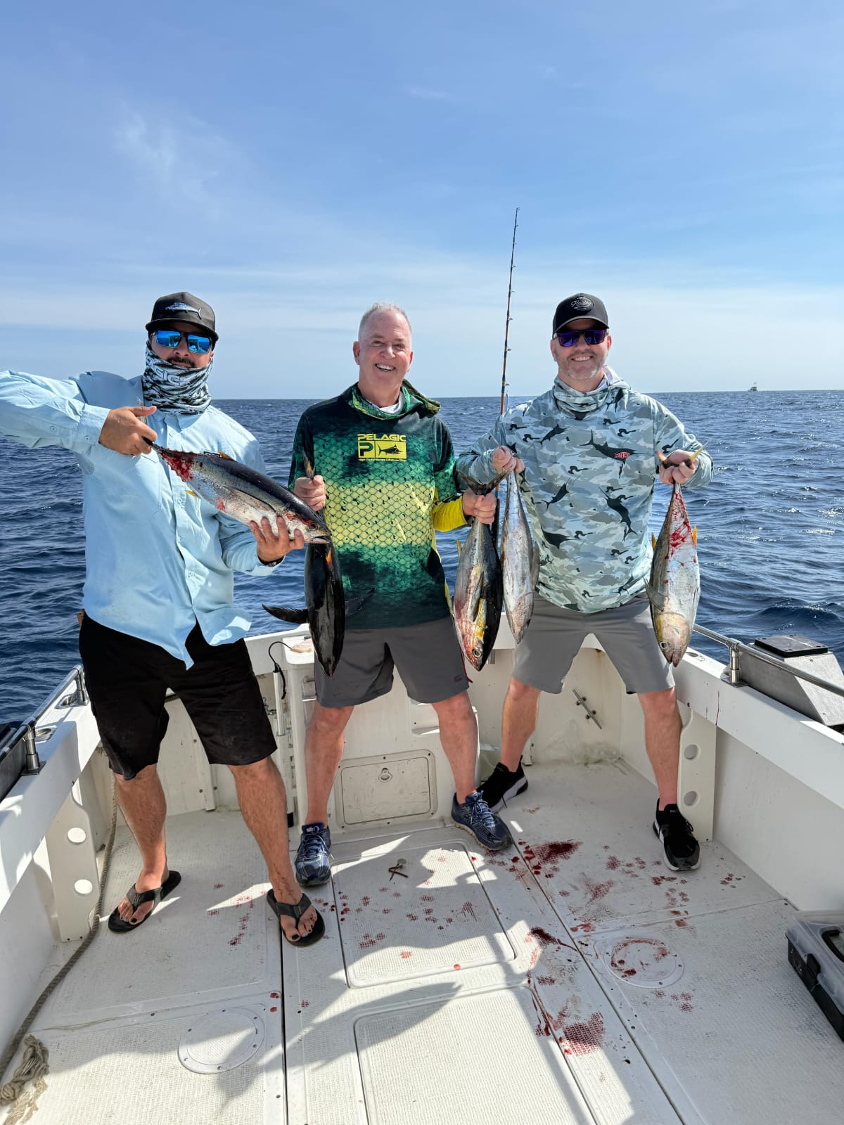 Angler smiling with a yellowfin tuna aboard a Daliken Sportfishing panga in Los Cabos
