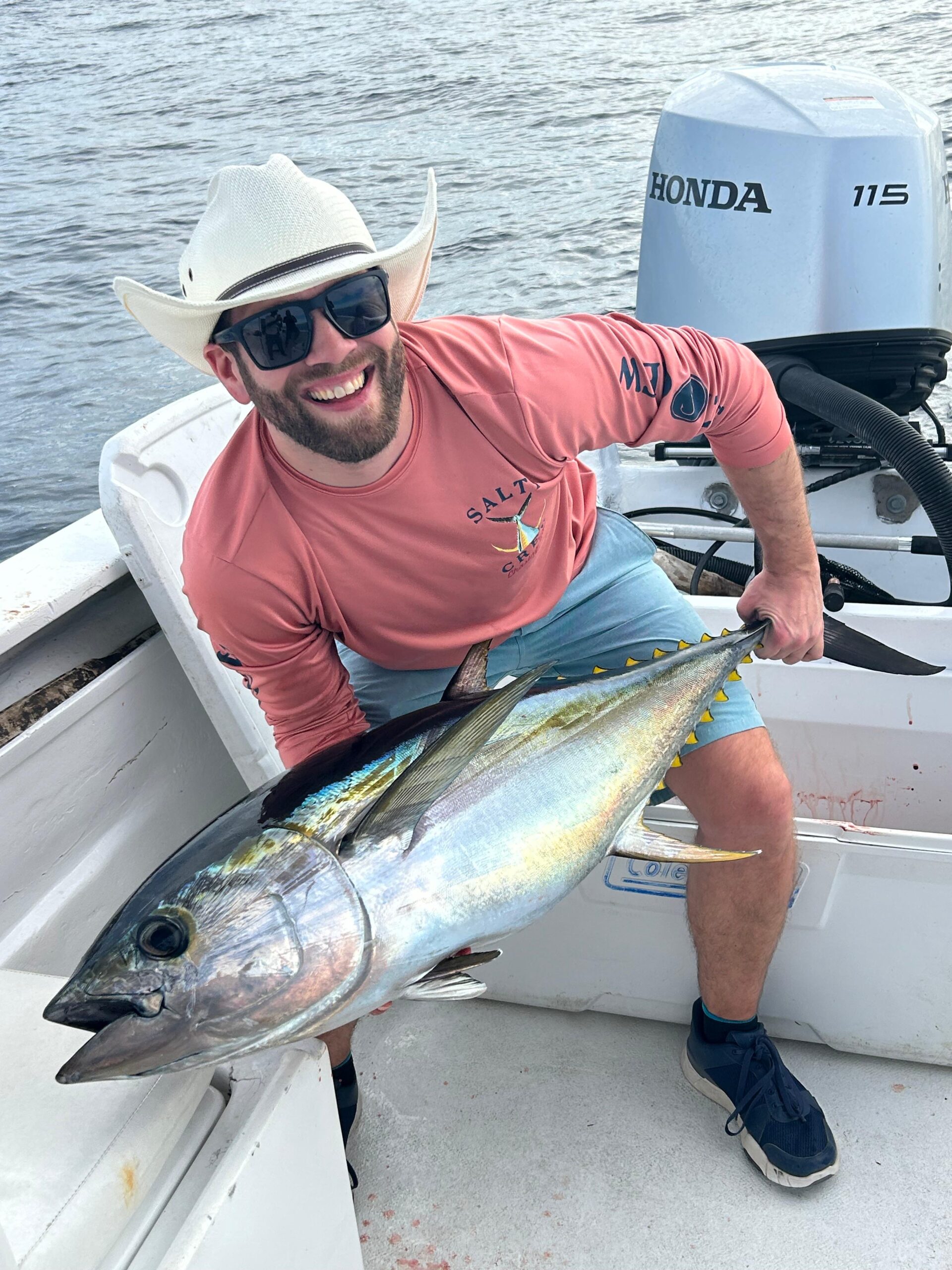 Client holding a yellowfin tuna caught offshore near San José del Cabo with Daliken Sportfishing