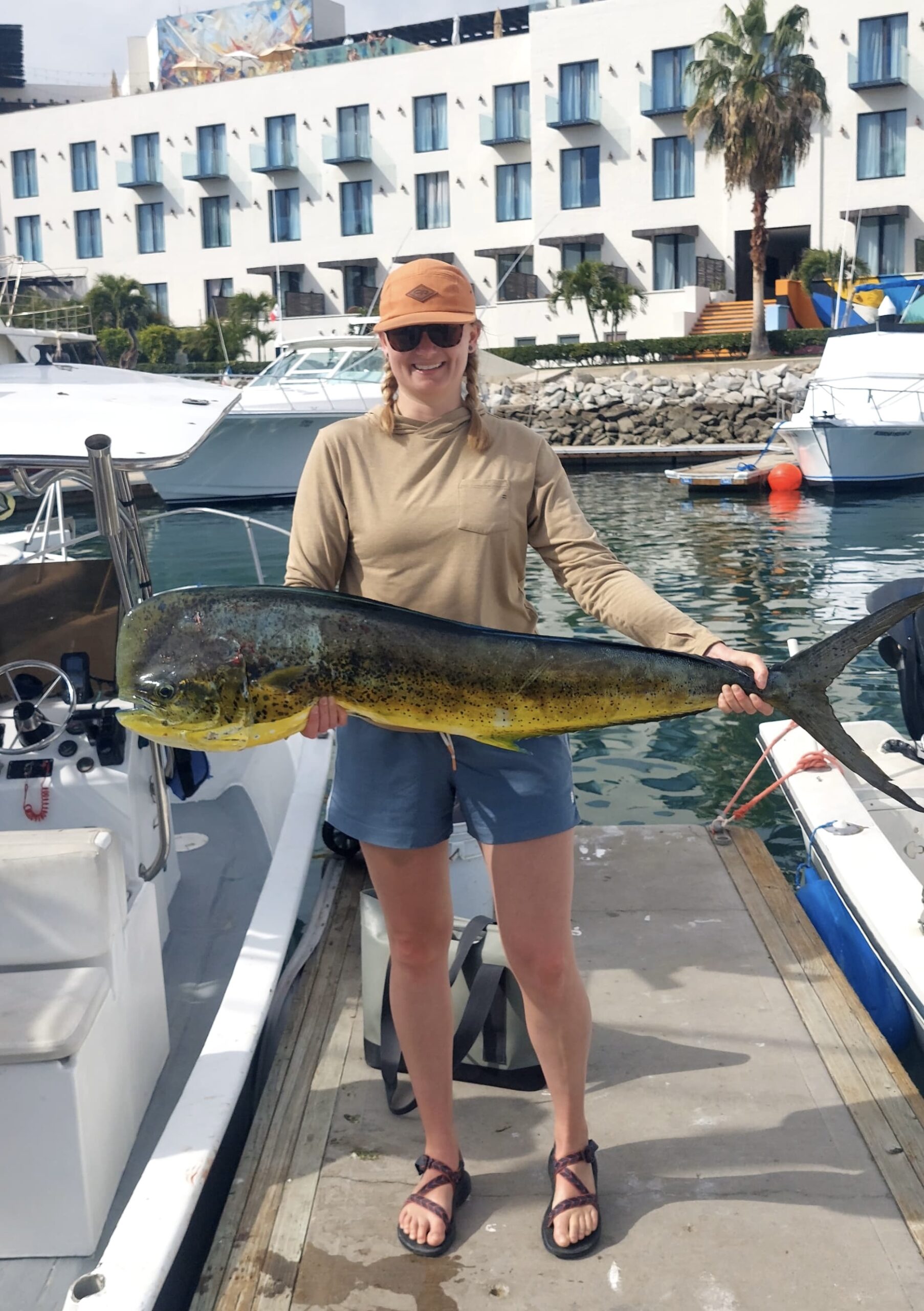 Villa La Valencia Los Cabos guests holding a large mahi mahi (dorado) on a private charter departing from San José del Cabo