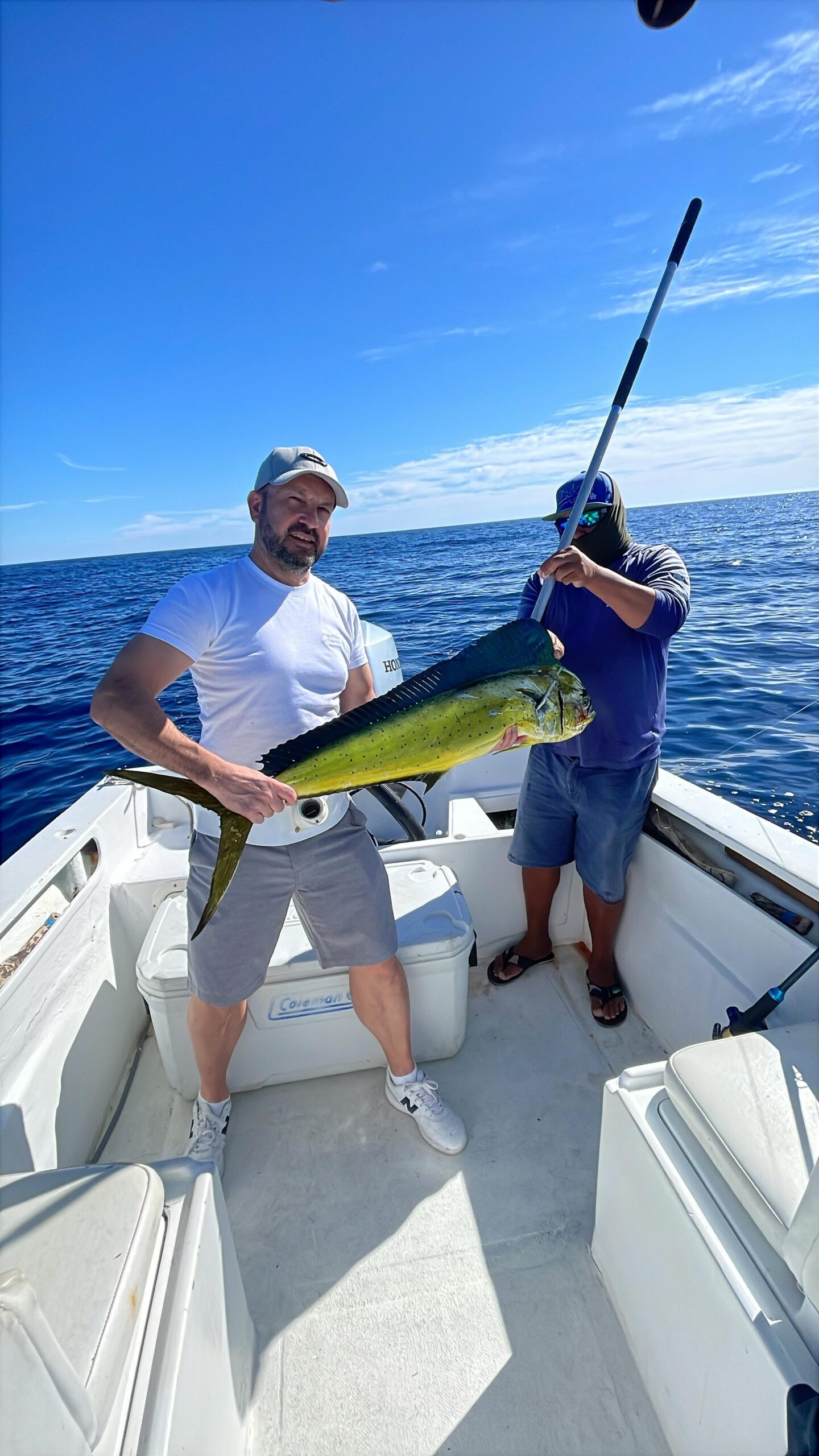 Client with a fresh mahi mahi dorado on a private fishing charter in San José del Cabo