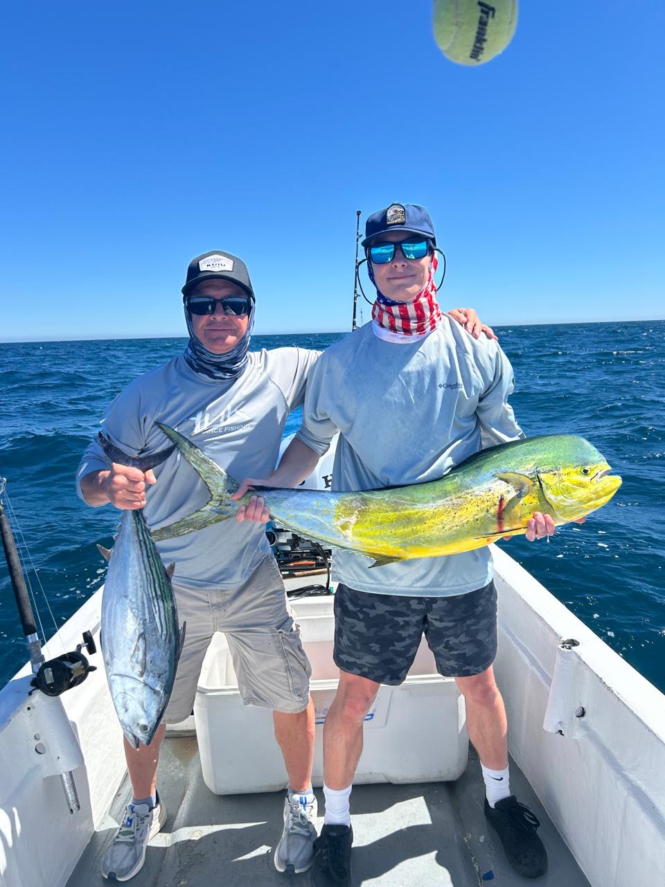Clients posing with dorado caught on a private San Jose del Cabo fishing charter