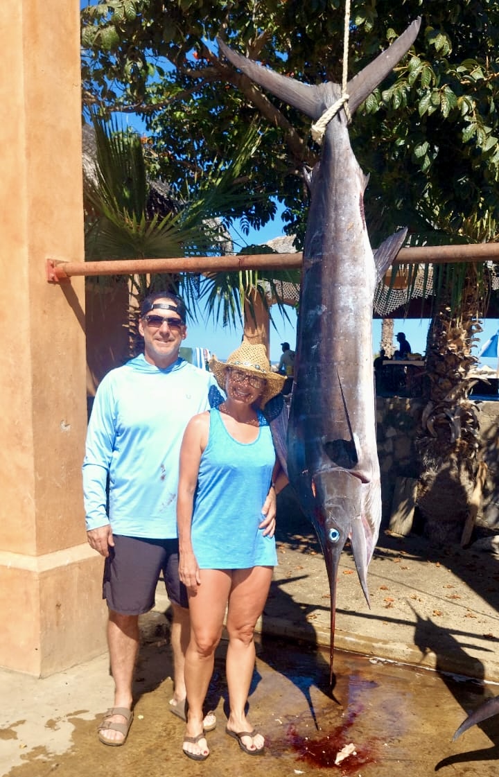 Clients in San José del Cabo showing their fresh catch after a successful private fishing charter
