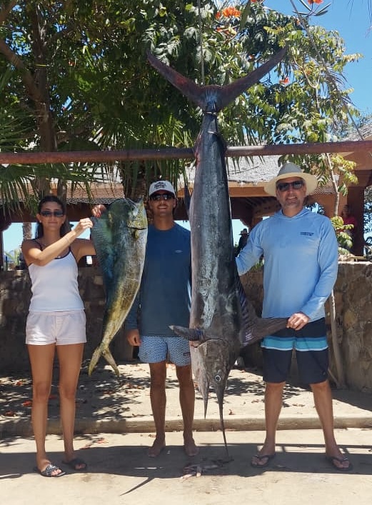 Featured San José del Cabo fishing report photo showing happy clients with fresh dorado catch on a private charter boat