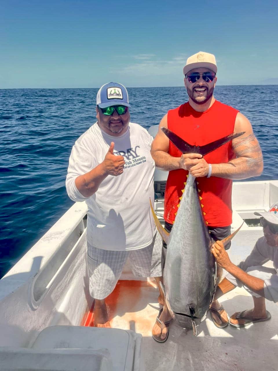 Two anglers with a big yellowfin tuna caught offshore with Daliken Sportfishing in Los Cabos