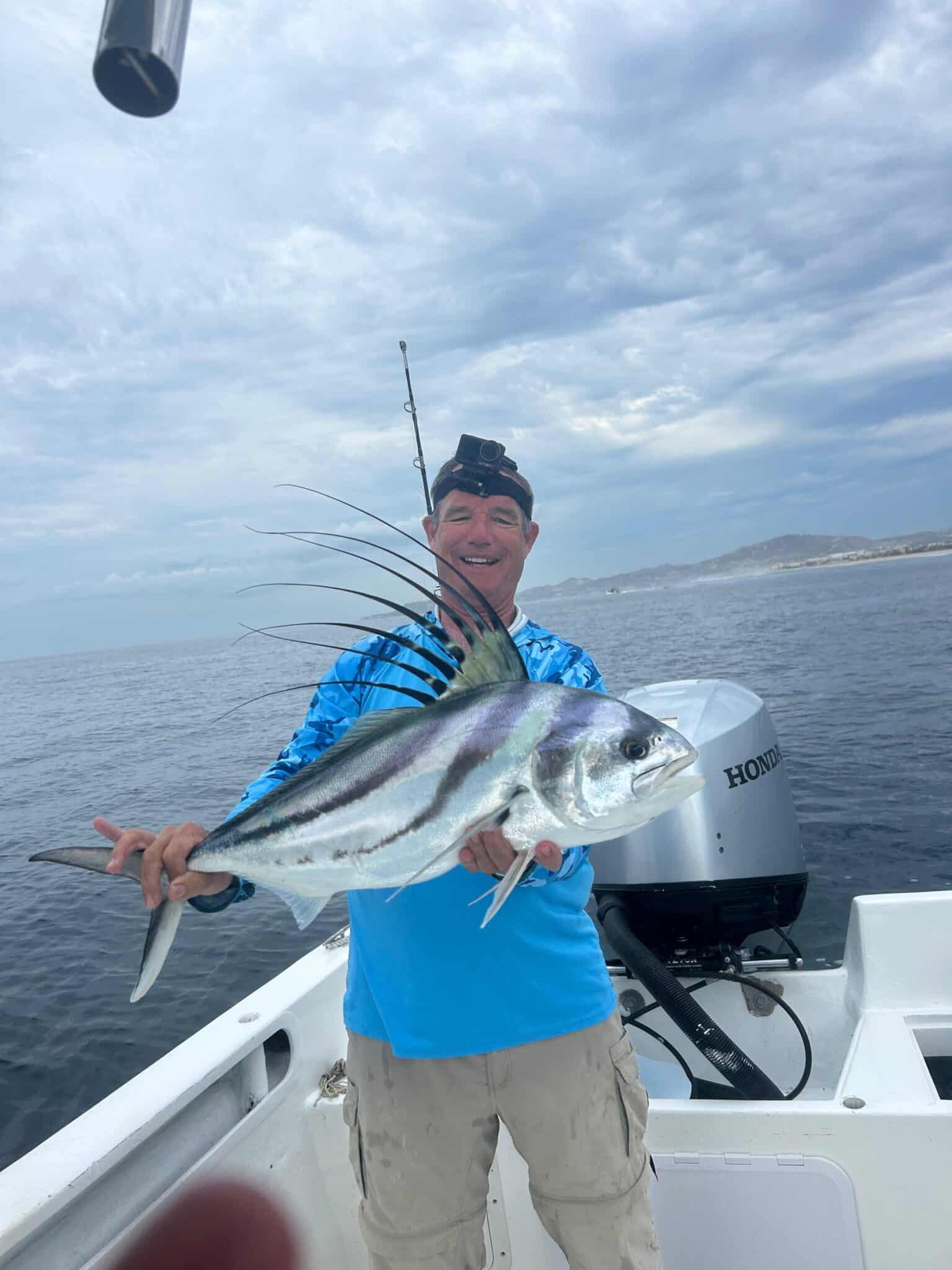 Angler holding a roosterfish caught inshore with Daliken Sportfishing near San Jose del Cabo