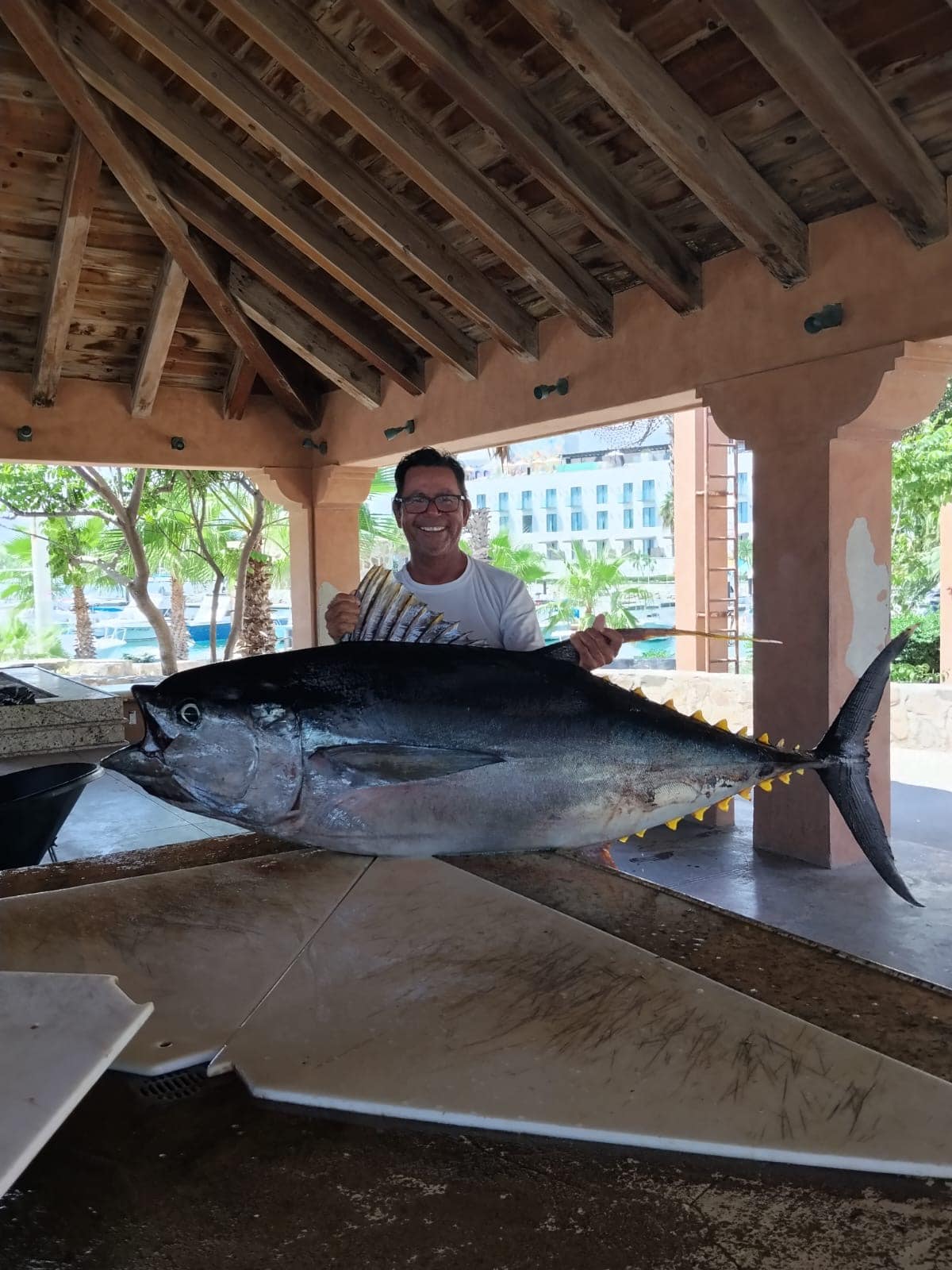 Captain Pancho with a large yellowfin tuna at the fish cleaning station, Puerto Los Cabos Marina